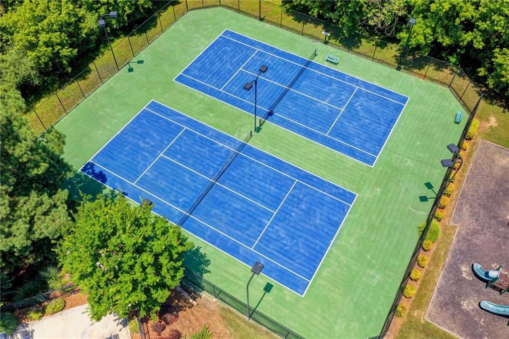 Community tennis courts surrounded by trees