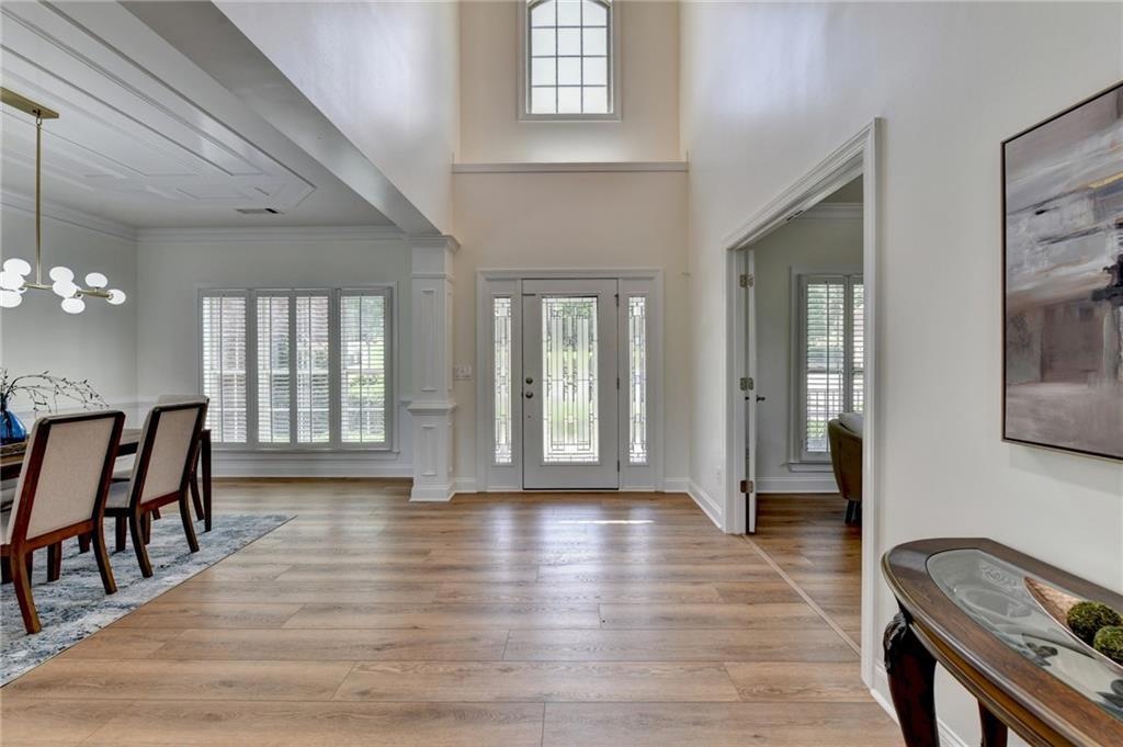 Two-story foyer with replaced flooring and redone stairs