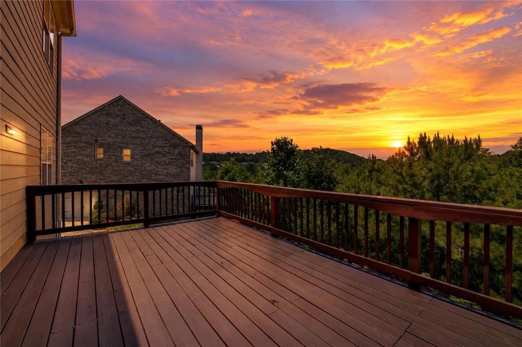 Upper deck at sunset overlooking the wooded setting